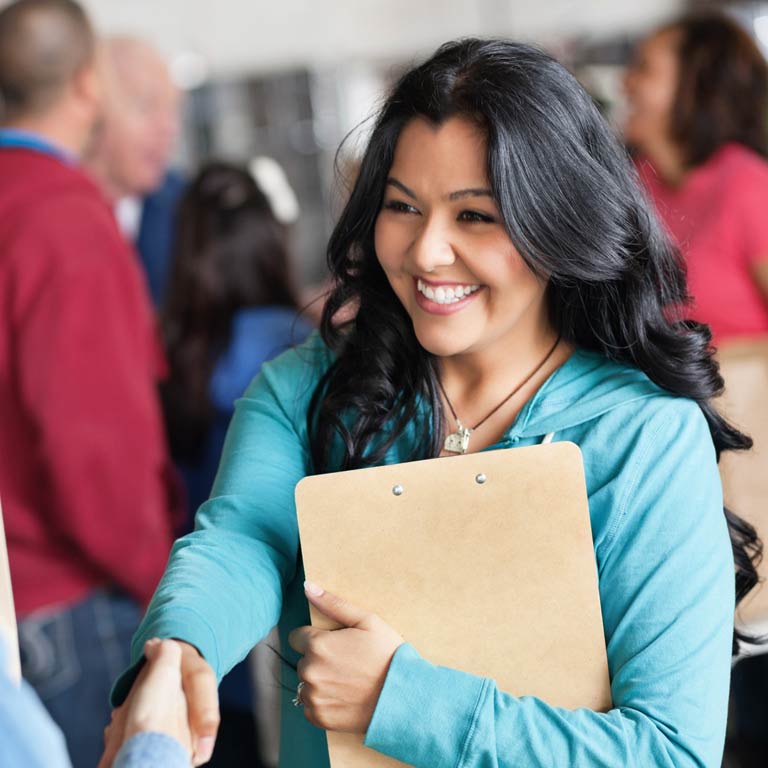 A SPEA graduate student shakes hands with a business leader.