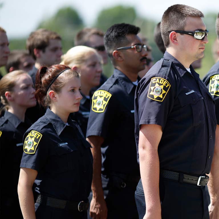 Police cadets stand at attention.