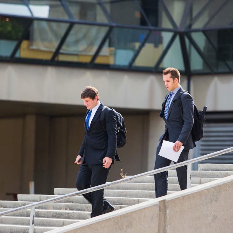 Students walk down the SPEA building steps.