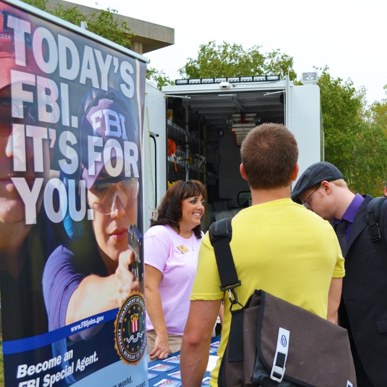 SPEA students stand at a public safety carer fair booth.